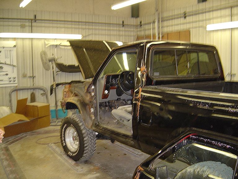 1989 Ford Ranger with hood and door open, undergoing repairs