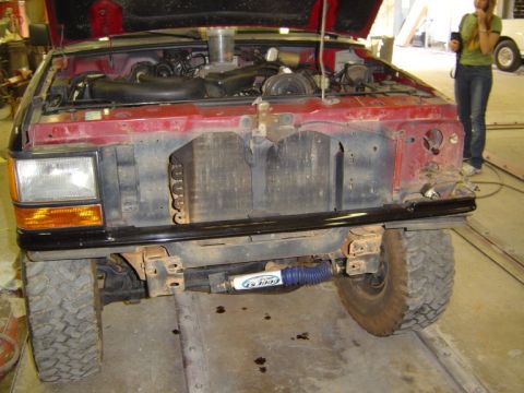 1989 Ford Ranger - Front view of a 1989 Ford Ranger with its hood open, revealing the engine compartment and radiator.