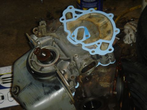 1986 Ford Mustang - Close-up of an engine water pump assembly, possibly undergoing maintenance or repair.