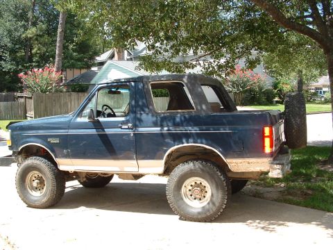 1993 Ford Bronco - This blue Ford Bronco features a removable top and is shown from the side.