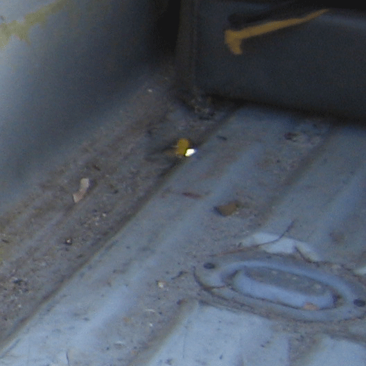 Close-up of a dirty ribbed metal truck bed or cargo floor