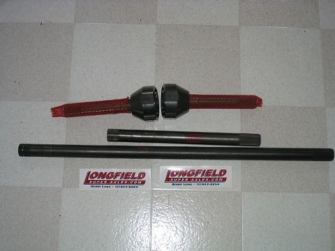 1986 Ford F-150 - Axle shafts and differential components are laid out on a checkered surface, with company branding visible.