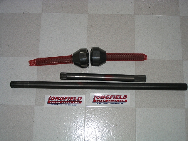 Two axle shafts and two differential components with red mesh covers, on a checkered floor. "LONGFIELD SUPER AXLES.COM" stickers are visible