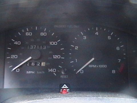 1993 Ford Probe - The dashboard displays the vehicle's speed, RPM, and odometer reading, along with a fuel gauge indicator.