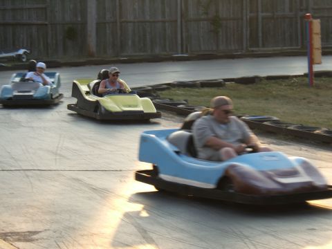 1998 Ford Taurus - Bumper cars race on a track, with multiple vehicles and drivers visible in the scene.