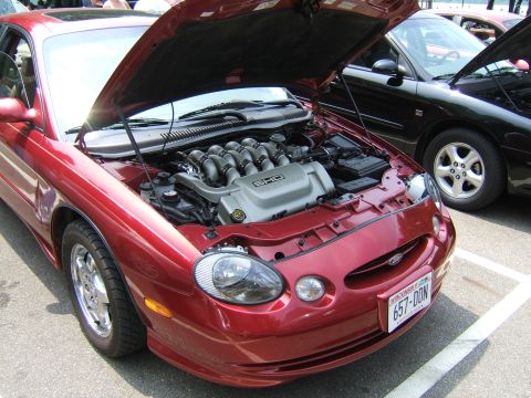 1998 Ford Taurus - 1998 Ford Taurus SHO engine bay detail. Another car is visible in the background.