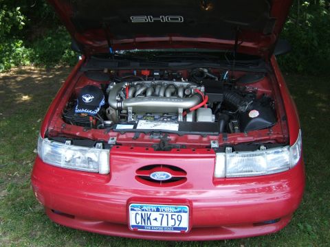 1998 Ford Taurus - This 1998 Ford Taurus SHO features its V8 engine with the hood open, displaying the SHO badging on the underside of the hood.