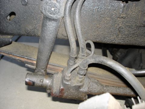 1978 Ford F-250 - Detail of hydraulic lines and steering mechanism on a vehicle's suspension system.