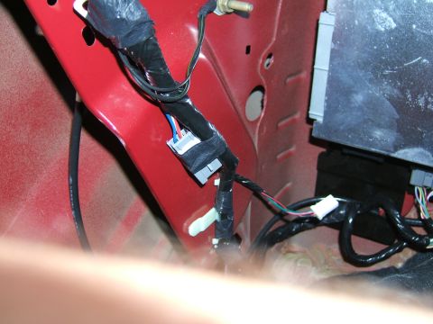 1998 Ford Taurus - Close-up view of a vehicle's internal wiring harness and an electronic control module, with visible text from Supermotors.net.