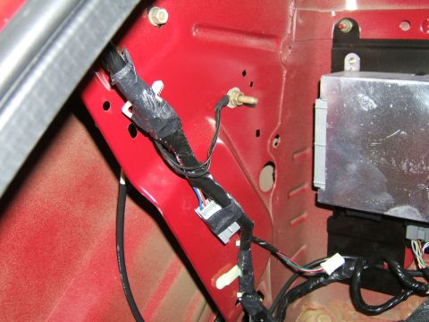 1998 Ford Taurus - Close-up of a vehicle's interior wiring and electronic control unit.