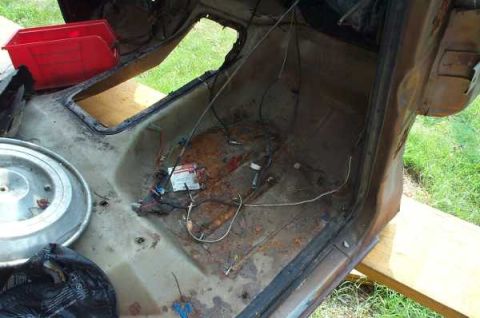 1979 Ford Bronco - Interior view of a vehicle undergoing restoration, with exposed floor and wiring harness.