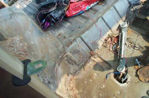 1979 Ford Bronco - The interior of the vehicle shows significant rust and debris, with some wiring exposed.