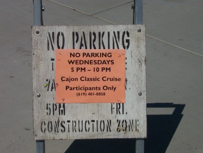 1995 Ford Bronco - A sign indicates parking restrictions for the Cajon Classic Cruise event, with additional text about a construction zone.