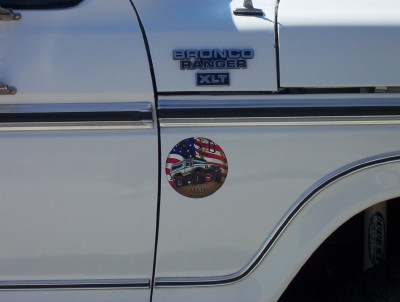 1995 Ford Bronco - A white 1995 Ford Bronco Ranger XLT is shown from the side, an American flag sticker with a Bronco graphic.