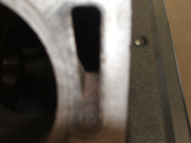 Close-up of a metal engine component with a dark opening