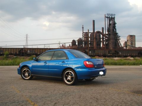2002 Subaru Impreza - Blue 2002 Subaru Impreza sedan parked in front of an industrial complex.