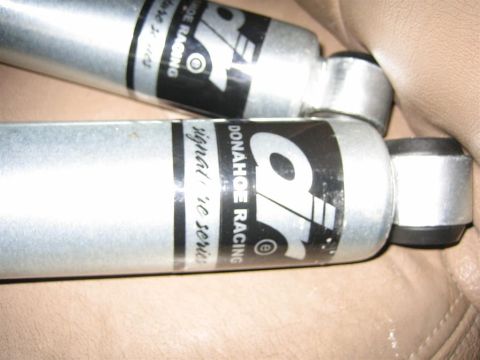 1994 Ford Bronco - Close-up of two shock absorbers with visible branding and series information.