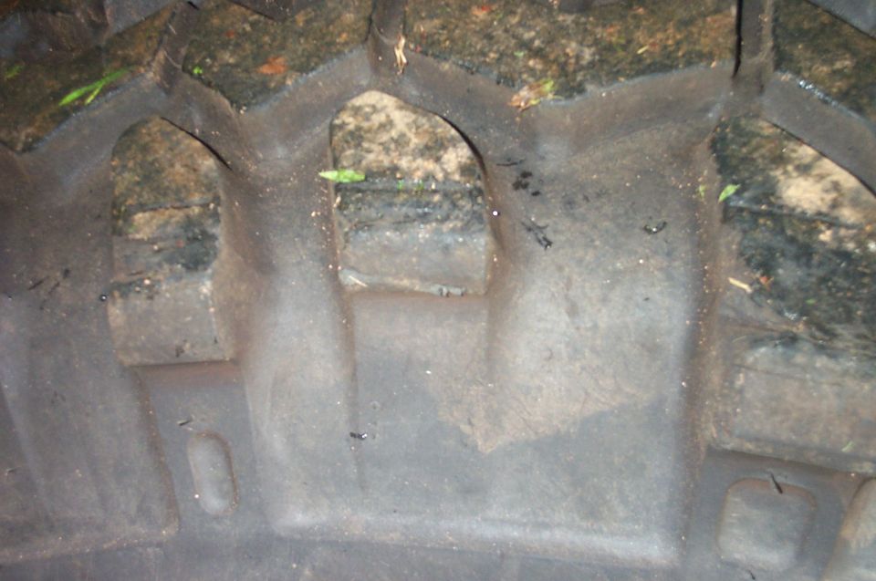 Close-up of a tire tread with mud and debris in the grooves