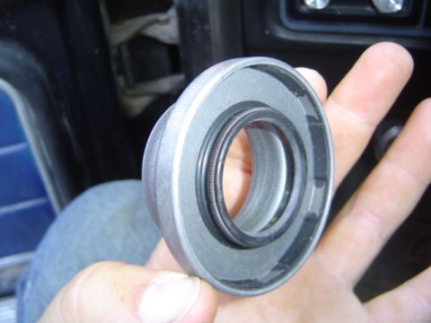 1979 Ford Bronco - Close-up of a metal part with a rubber seal being held in a person's hand.