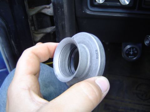 1979 Ford Bronco - Metal part with '2300' stamped on it being held inside a vehicle.