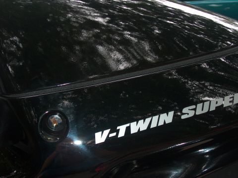 2002 Suzuki TL1000R - Close-up of a black motorcycle's side panel, displaying "V-TWIN SUPER" lettering.
