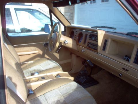 1985 Ford Bronco II - Interior view of a 1985 Ford Bronco II, tan upholstery and a dashboard with radio and gauges.