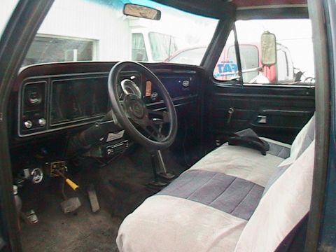 1977 Ford F-250 - The interior of a truck is shown, the dashboard, steering wheel, and seats. A watermark is visible at the bottom right.