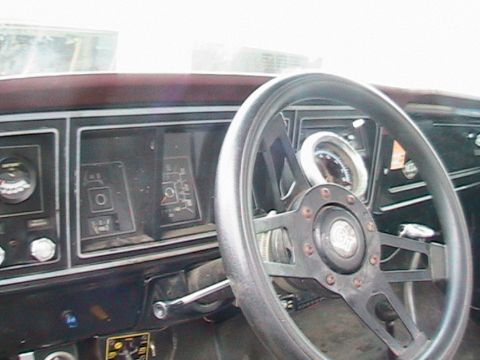 1977 Ford F-250 - The interior of a 1977 Ford F-250 shows a dashboard with various gauges and a steering wheel.