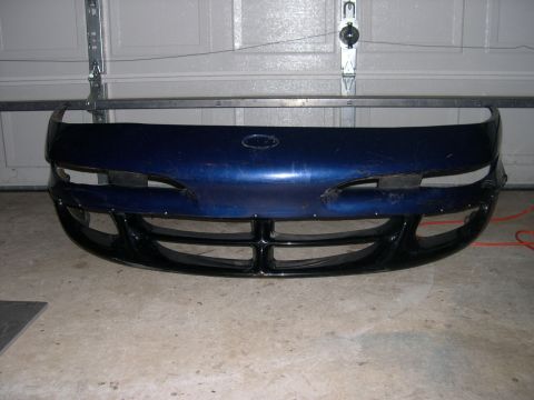 1997 Ford Probe - Front bumper assembly, likely for a car, shown indoors.