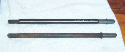 1986 Ford Bronco - Two metal rods are shown on a white cloth, one appears to be new, or have markings from, a new part.