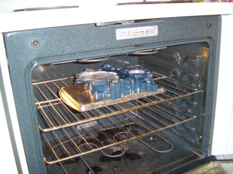 1986 Ford Bronco - Engine part being baked in an oven, likely for curing paint or sealant.