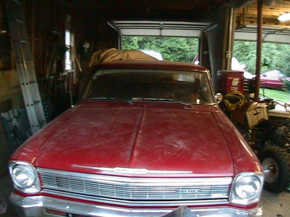 Dusty maroon 1960s Chevrolet Nova front end parked in a garage