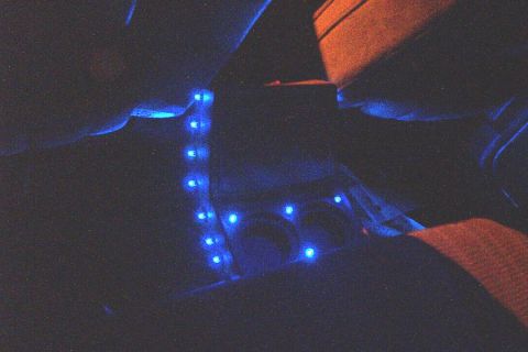 1985 Ford Crown Victoria LTD - Blue LED lights illuminate the center console area of a car's interior.