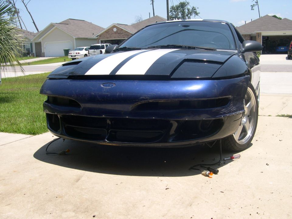 Blue Ford Probe front bumper with white racing stripes on hood, detached