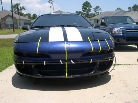 1997 Ford Probe - Front view of a blue 1997 Ford Probe with racing stripes and yellow tape on the bumper.