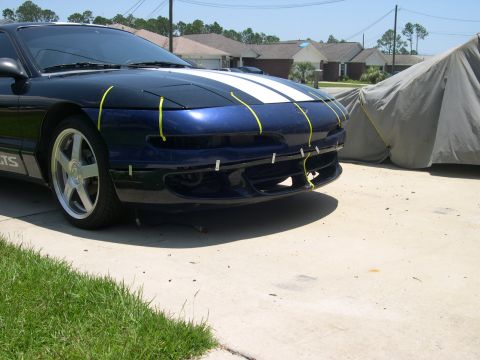 1997 Ford Probe - A blue 1997 Ford Probe is parked in a driveway, with yellow tape applied to its front bumper.