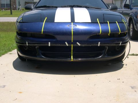 1997 Ford Probe - Front view of a blue 1997 Ford Probe, white racing stripes and yellow tape applied to the bumper area.