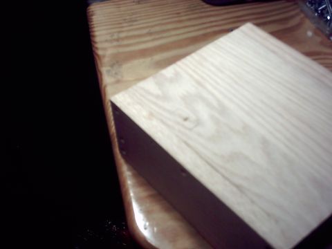 1990 Ford Bronco - A wooden block sits on a table, with a dark area to the left.