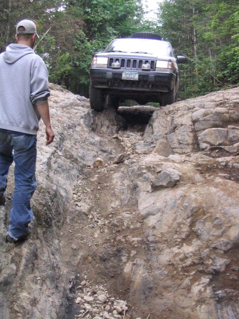 2000 Jeep Cherokee - A Jeep Grand Cherokee tackles a challenging rocky terrain on an off-road trail.