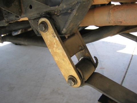 1994 Ford Bronco - Detail of a vehicle's suspension linkage, showing wear and rust on the metal components.