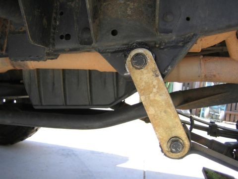 1994 Ford Bronco - Close-up view of the rusty undercarriage and suspension parts of an older vehicle.