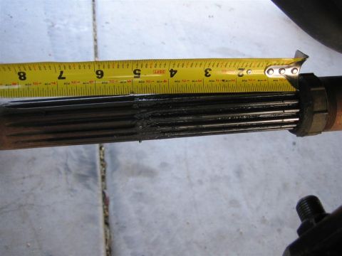 1994 Ford Bronco - A splined shaft is measured with a yellow tape measure, indicating a length of approximately 3 inches.