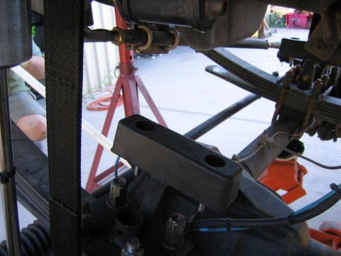 1994 Ford Bronco - Vehicle suspension parts are visible, with a black rubber bump stop in the foreground.