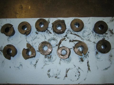 1994 Ford Bronco - Several metal parts, appearing to be washers and springs, are laid out on a blue shop towel, showing signs of wear and tear.