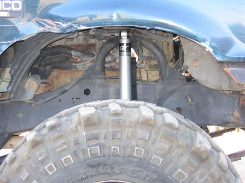 1994 Ford Bronco - Close-up of the front suspension and tire on a 1994 Ford Bronco.