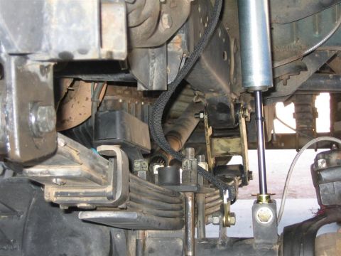 1994 Ford Bronco - Undercarriage view shows suspension components including leaf springs and a shock absorber.