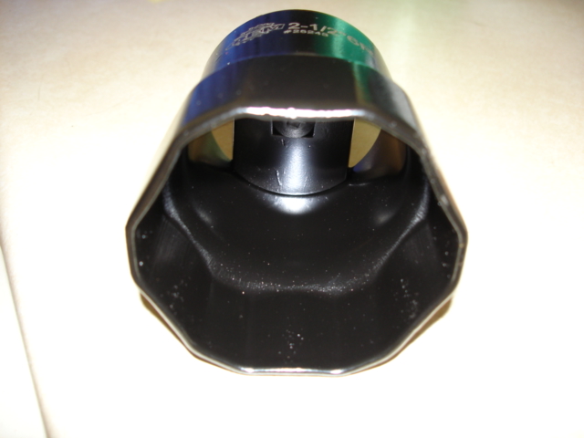 Close-up of a black socket wrench adapter with text that reads '2-1/4' on the top band