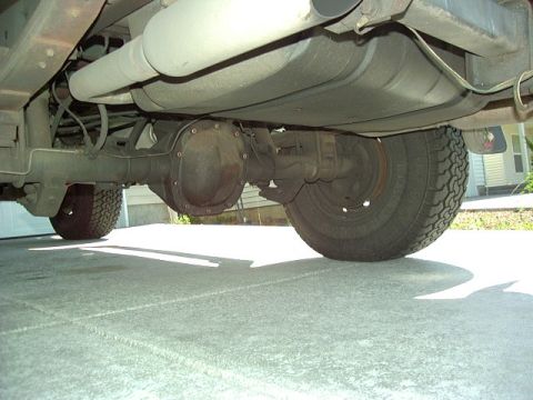 1991 Ford Bronco - Underside view shows the rear axle, differential, fuel tank, and exhaust system of a vehicle.