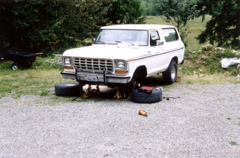 1979 Ford Bronco - This 1979 Ford Bronco is elevated on jack stands, with its front wheels removed, indicating it is in the process of being repaired.