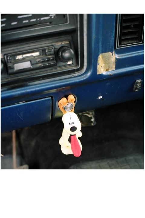 1979 Ford Bronco - Interior view of a vehicle's dashboard a JVC radio and a novelty dog keychain.